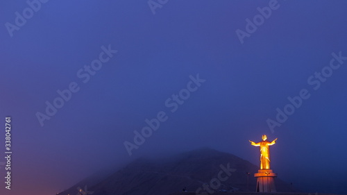 Aerial view of Cristo del Pacifico and Morro Solar hill in the background night to day timelapse.