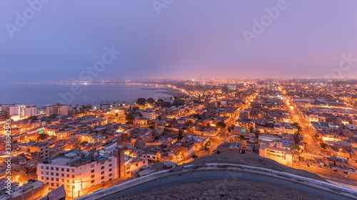 Panoramic skyline of Lima city from above with many buildings aerial night to day transition timelapse. Lima  Peru