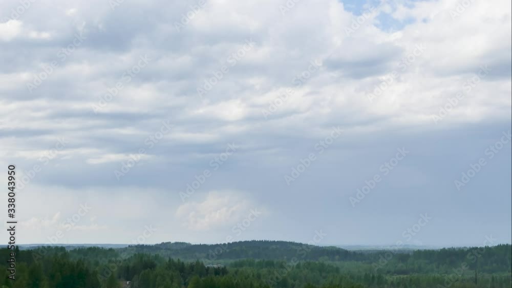 aerial panoramic time lapse of summer rain over the green forest and white clouds running on the blue sky. View from the top of the hill in 4k aerial panoramic time lapse of summer rain over the green forest and white clouds running on the blue sky. View from the top of the hill in 4k