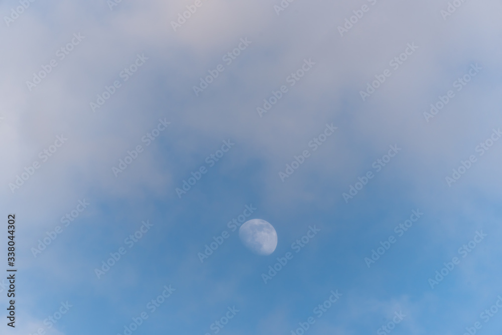 Three Quarter Moon in a Blue Sky with Clouds Three Quarter Moon in a Blue Sky with Clouds