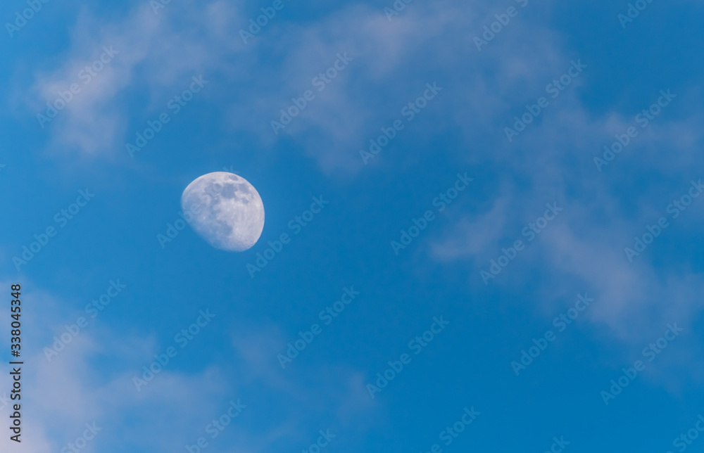 Three Quarter Moon in a Blue Sky with Clouds Three Quarter Moon in a Blue Sky with Clouds