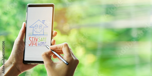 stay at home concept.Daughter draw picture for sending to parents or grandparents by phone.Using device to send messages to others