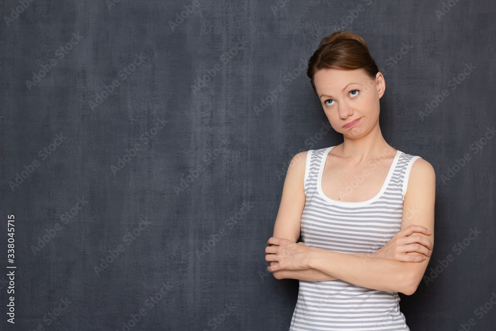 Portrait of bored tired woman crossing arms over body and pouting lips Portrait of bored tired woman crossing arms over body and pouting lips