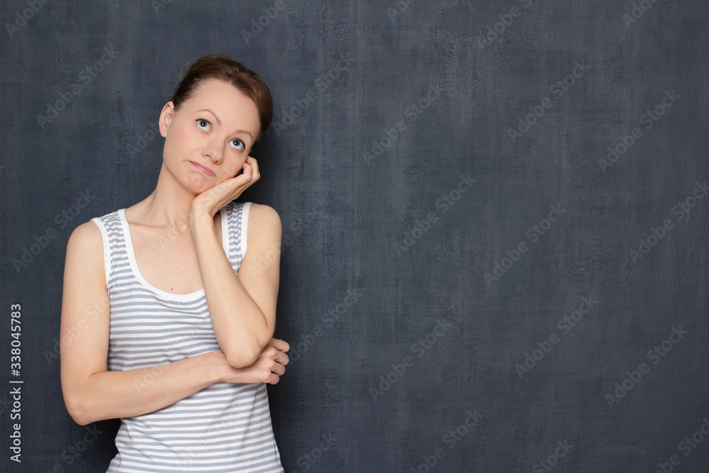 Portrait of thoughtful tired young woman propping up head with hand Portrait of thoughtful tired young woman propping up head with hand