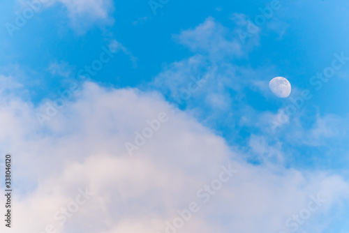 Three Quarter Moon in a Blue Sky with Clouds