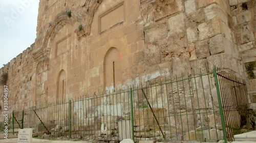 View of the Golden gates in the Old City Walls of Jerusalem in Israel. It located in an ancient Muslim cemetery. Tilt down.