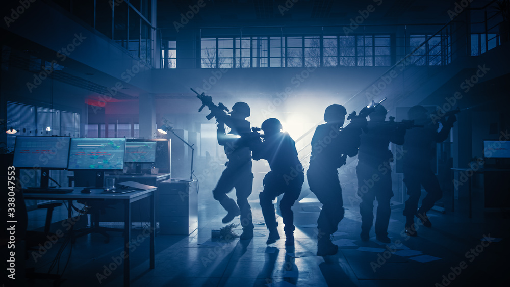 Masked Squad of Armed SWAT Police Officers Storm a Dark Seized Office Building with Desks and Computers. Soldiers with Rifles and Flashlights Move Forwards and Cover Surroundings. Masked Squad of Armed SWAT Police Officers Storm a Dark Seized Office Building with Desks and Computers. Soldiers with Rifles and Flashlights Move Forwards and Cover Surroundings.