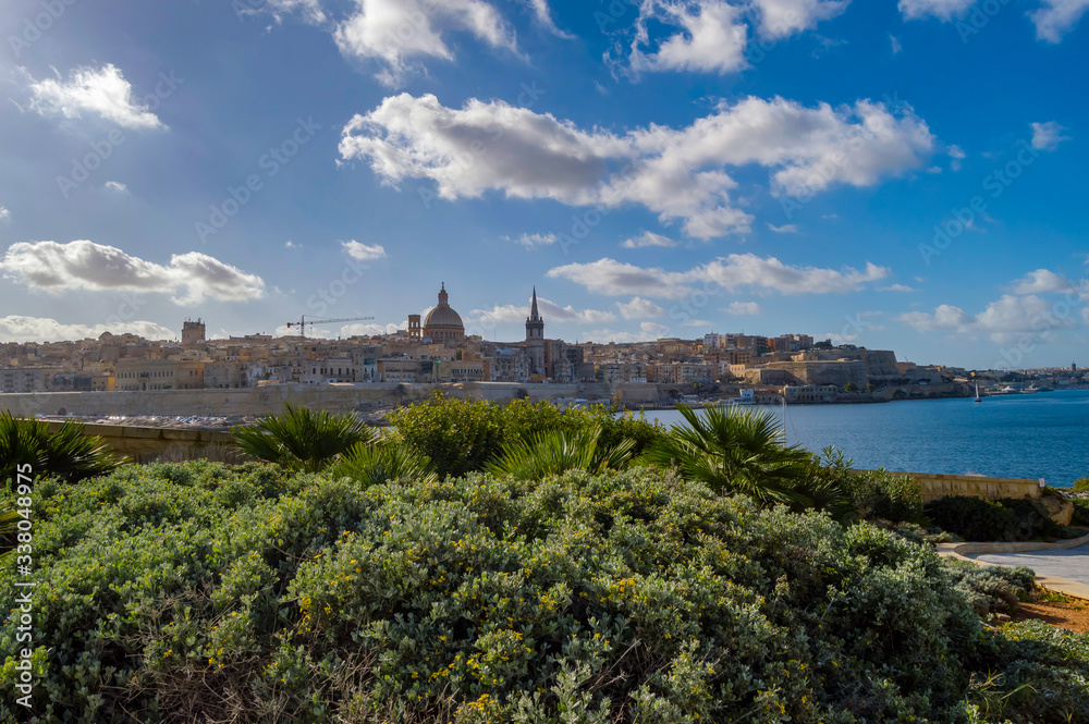 Panoramic view of Valletta Skyline at beautiful sunset from Sliema with churches