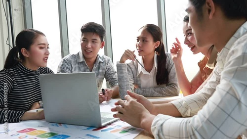 Group of asian young modern people in smart casual wear having a brainstorm meeting while sitting in office background. Business meeting, Planning, Strategy, New business development, Startup concept.