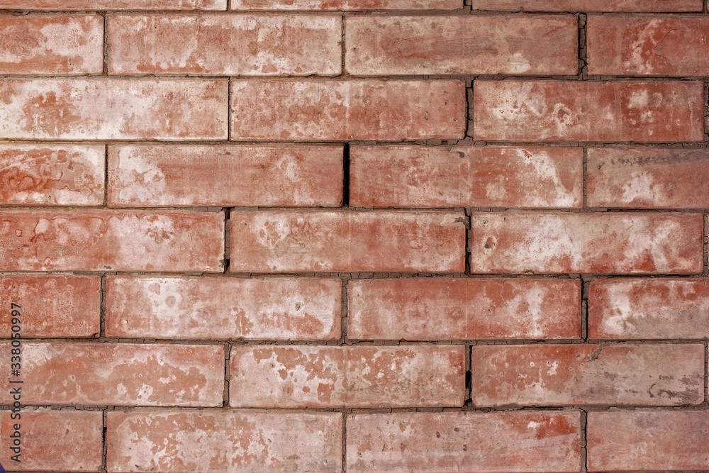 Fototapeta premium Old red brickwork on the back of the oven in a private house in the village