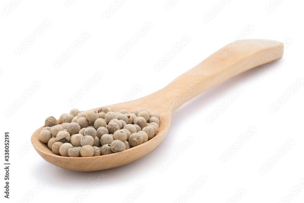 Closeup of heap of white peppers seed in wooden spoon on white background. Isolated with clipping path. Closeup of heap of white peppers seed in wooden spoon on white background. Isolated with clipping path.