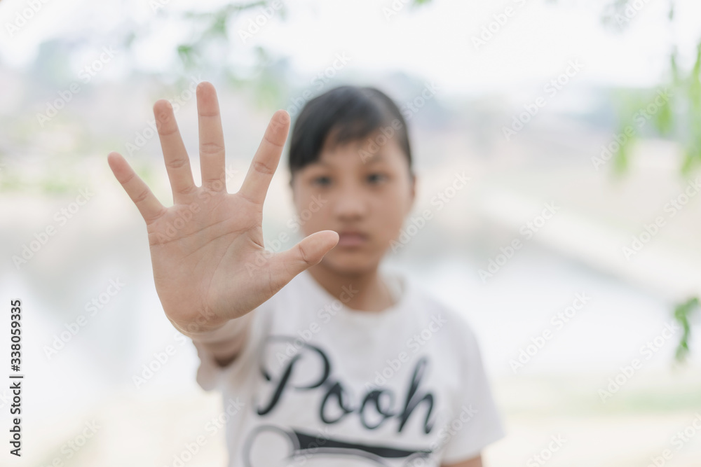 Young girl showing stop hand nature background Young girl showing stop hand nature background