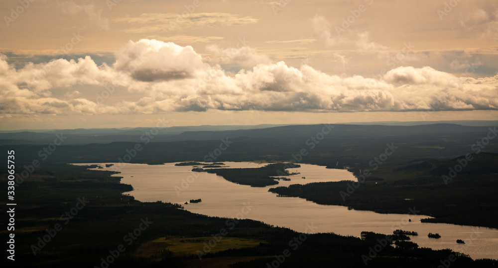 panoramic overview over a valley with forest and lakes in sweden on a cloudy day