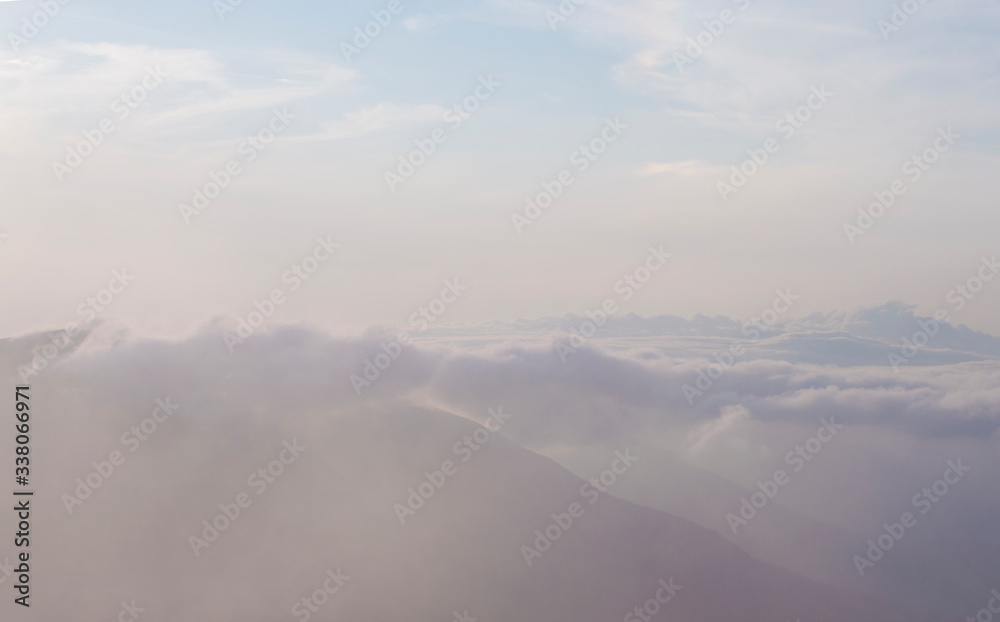clouds on a background of mountains in a haze