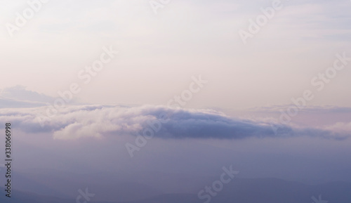 clouds on a background of mountains in a haze