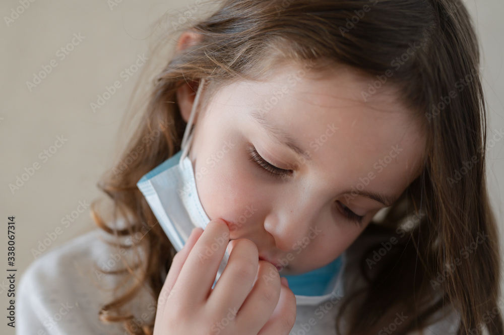 COVID-19 virus flu quarantine concept of sad small kid wearing medical mask COVID-19 virus flu quarantine concept of sad small kid wearing medical mask