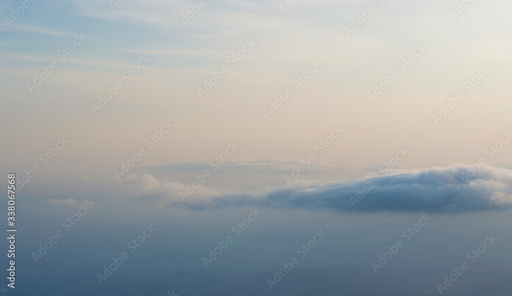 clouds on a background of mountains in a haze clouds on a background of mountains in a haze