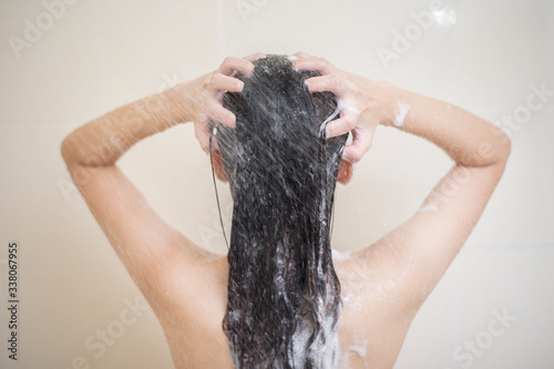 Happy beautiful woman is taking a shower