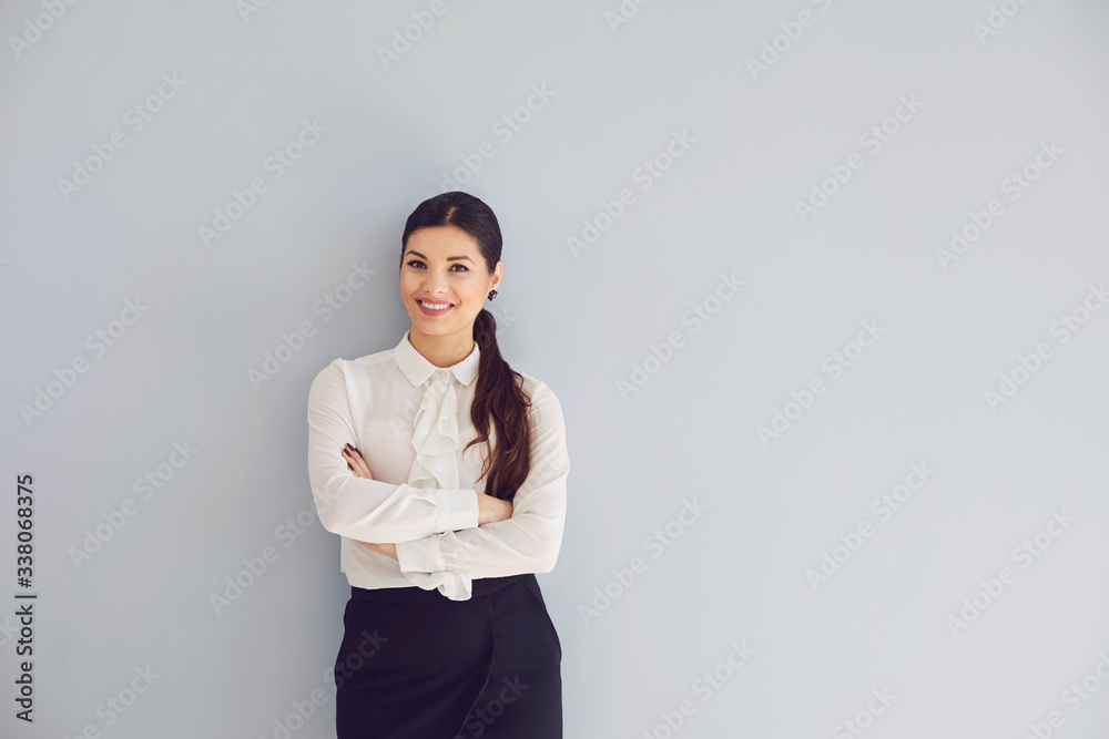 Young woman in white shirt smiling laughs joyful happy positive on a gray background. Young woman in white shirt smiling laughs joyful happy positive on a gray background.