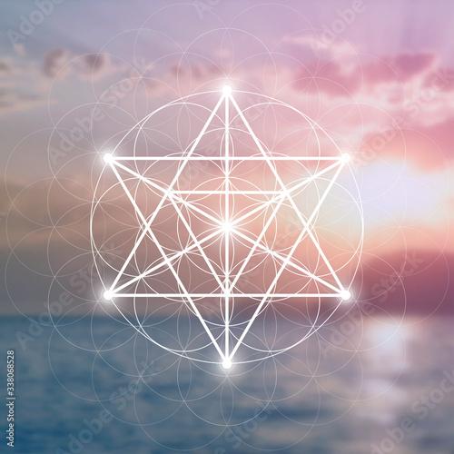Merkaba sacred geometry spiritual new age futuristic illustration with interlocking circles, triangles and glowing particles in front of blurry natural photographic background