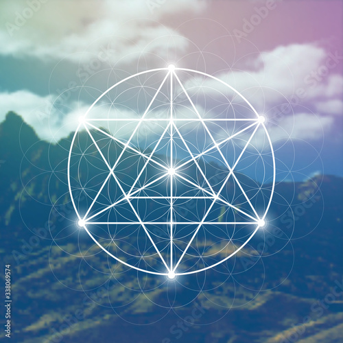 Merkaba sacred geometry spiritual new age futuristic illustration with interlocking circles, triangles and glowing particles in front of blurry natural photographic background