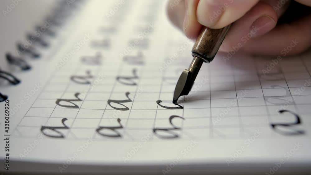Calligraphy in slow motion. Selective focus close-up shot of hand written page. Vintage ink pen and quill pen. Calligraphy in slow motion. Selective focus close-up shot of hand written page. Vintage ink pen and quill pen.