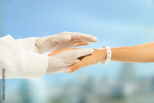 female doctor holding patients hand to providing compassion during difficult times