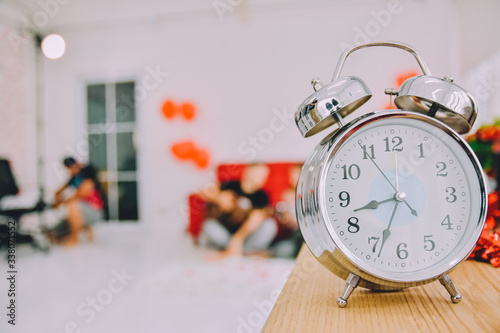 Clock on wood table to check the time stay at home