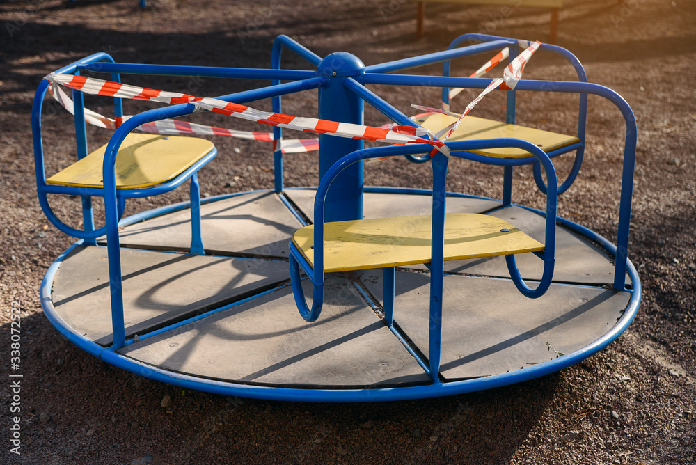 Children's playground closed and wrapped in alarm caution tape for global coronavirus quarantine.No children on playgrounds. Prevention of coronavirus COVID-19. Children's playground closed and wrapped in alarm caution tape for global coronavirus quarantine.No children on playgrounds. Prevention of coronavirus COVID-19.