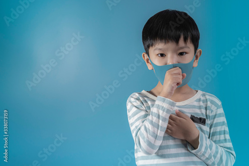 boy in medical face protection mask on blue background