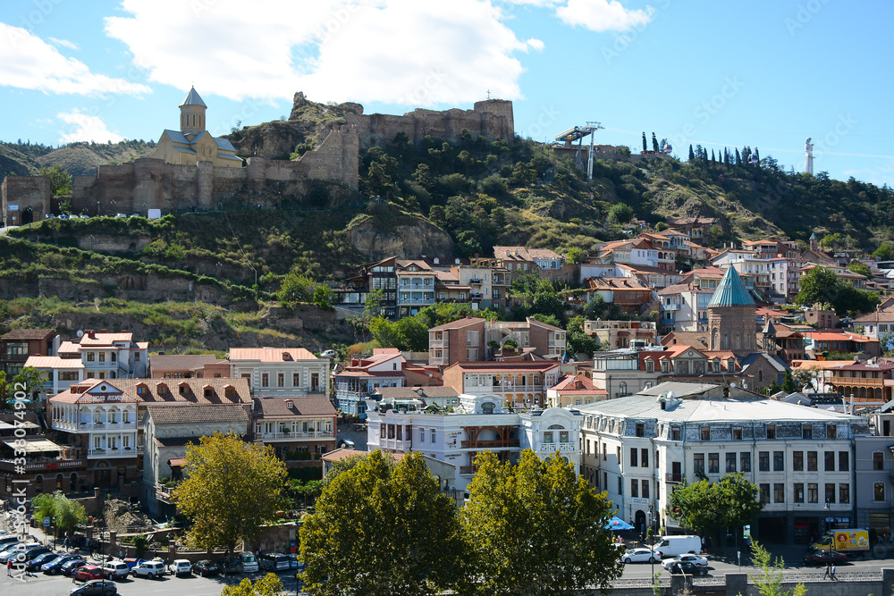 Naklejka premium Tbilisi, Georgia - October 4, 2018: View from Metekhi St. Virgin Church and Statue of King Vakhtang Gorgasali