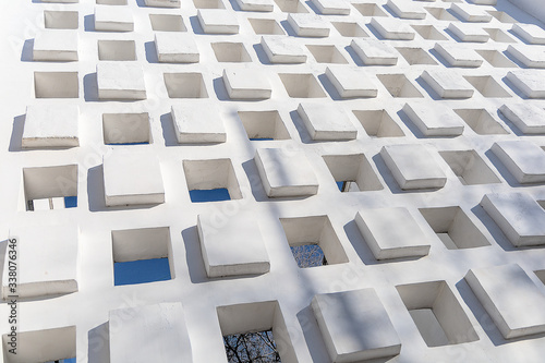View of a part of the reinforced concrete wall, made in the brutal style. The wall is white
