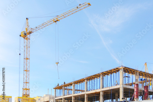 View of a reinforced concrView of the construction site. Tower crane at a construction site. Monolithic frame of the building