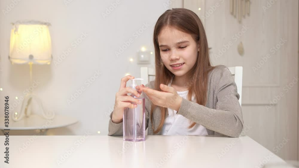 teen uses disinfectant to clean their hands. teen uses disinfectant to clean their hands.