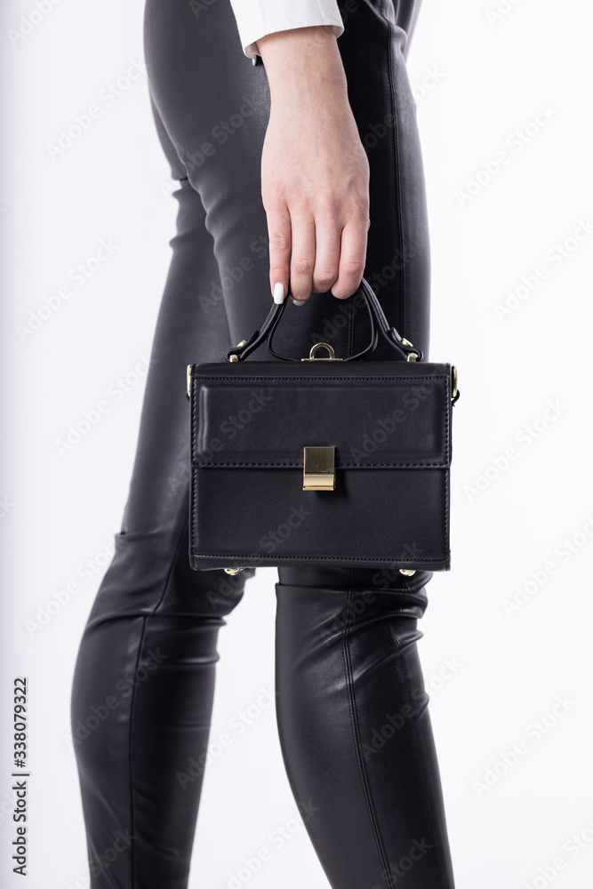 Model girl with leather elegant women bag. Fashionable female handbag, isolated Model girl with leather elegant women bag. Fashionable female handbag, isolated
