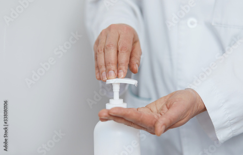 Hands using alcohol wash gel for cleaning sanitize gel pump dispenser. Bottle of hand disinfection gel, health care concept