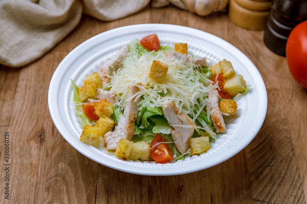 Salad caesar with chicken on white plate