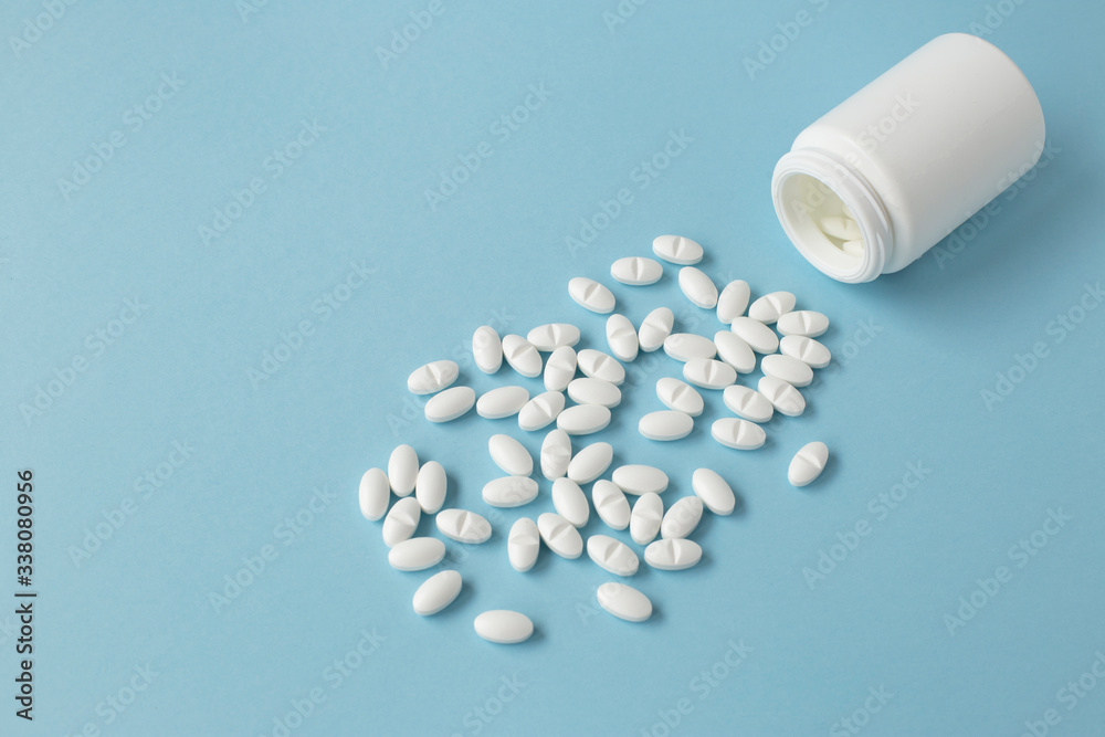 White pills scattered out of a can. Medical , sars virus self care concept White pills scattered out of a can. Medical , sars virus self care concept