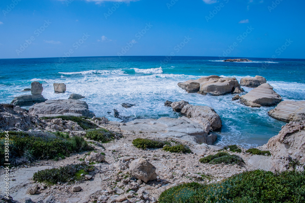 A fresh spring wind drives the waves to the coast of Cyprus. The Mediterranean Sea is painted with dark ultramarine and a luminous azure from the inside.     