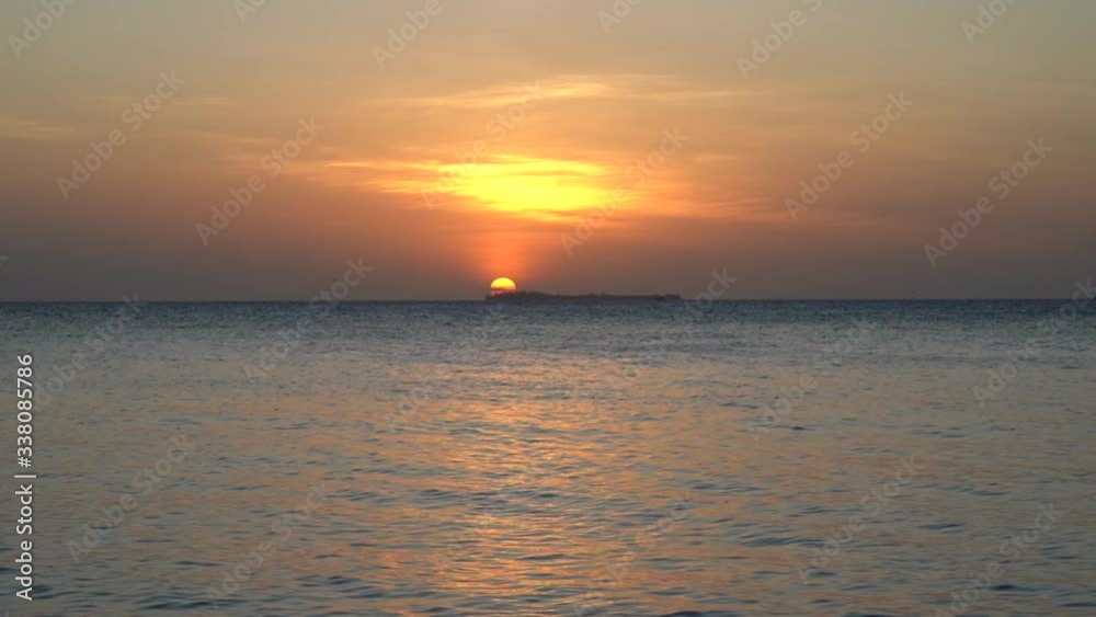 Sunset - Sun setting behind an island Sunset - Sun setting behind an island