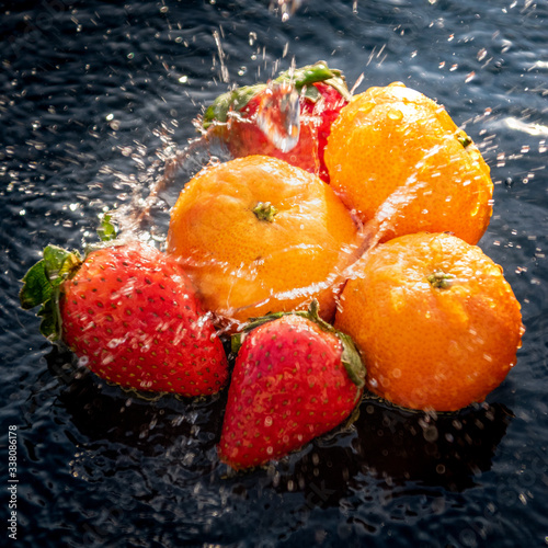 Fresh fruits splashing water photo