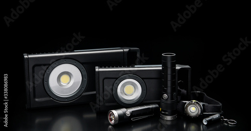 LED flashlights on a black back. Modern portable lighting.