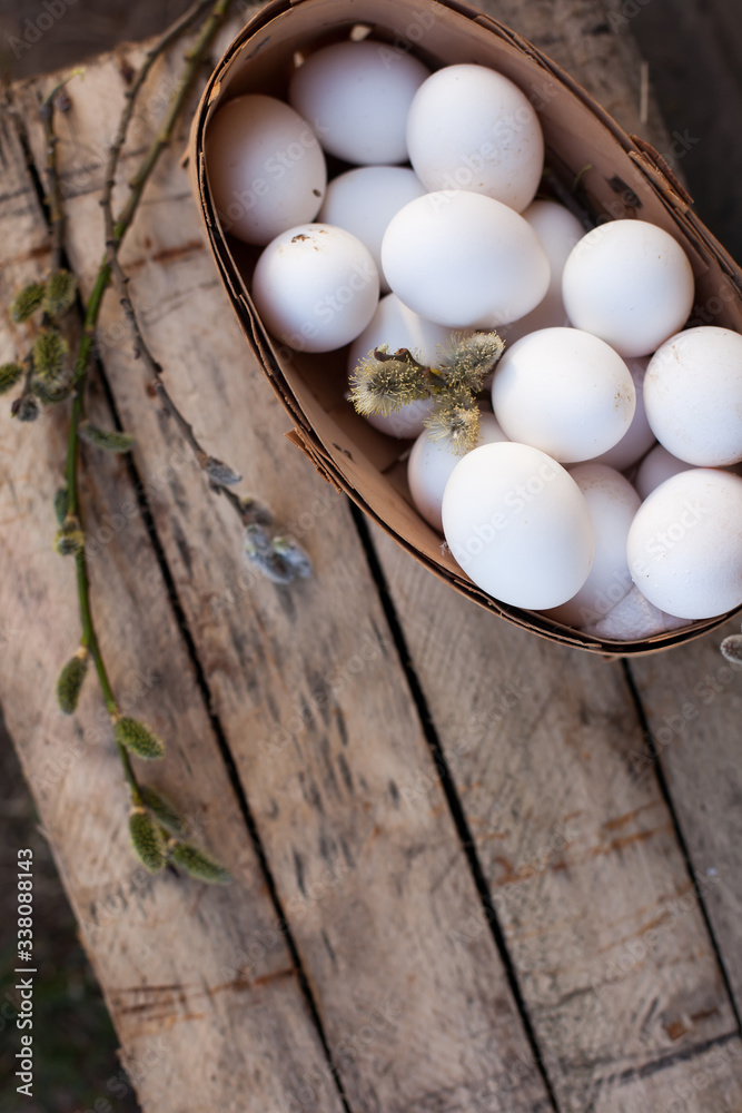 Chicken eggs in basket on wooden background Chicken eggs in basket on wooden background