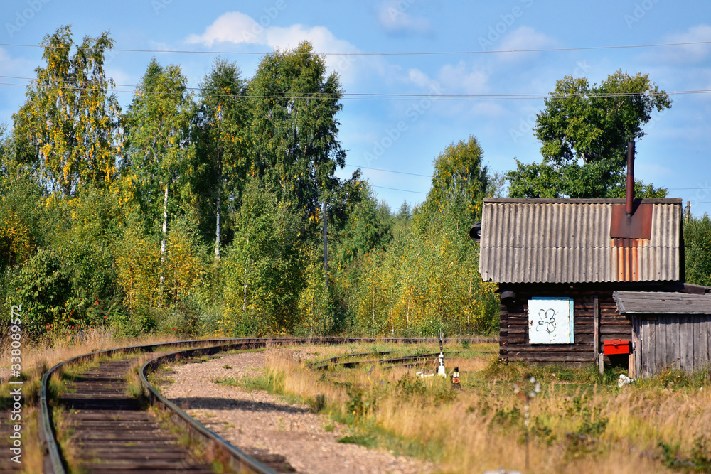 A house near the railway in the autumn deciduous forest A house near the railway in the autumn deciduous forest