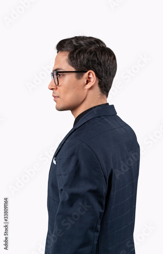 Businessman in glasses standing looking away to future perspectives isolated on white background. © VideoFlow