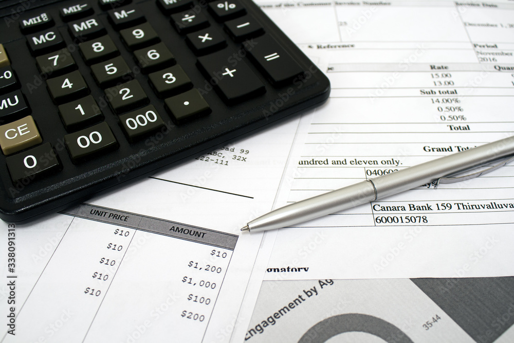 Calculator lying on the table with pen and documents with figures for accountants Calculator lying on the table with pen and documents with figures for accountants