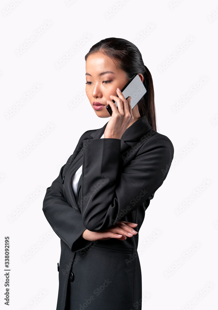Beautiful asian business woman talking on the phone. Isolated on white background. Beautiful asian business woman talking on the phone. Isolated on white background.