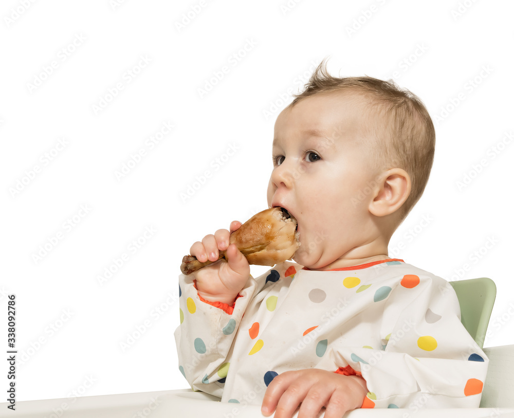 Portrait of hungry baby boy with fried chicken leg in his hand on white isolated background. Portrait of hungry baby boy with fried chicken leg in his hand on white isolated background.