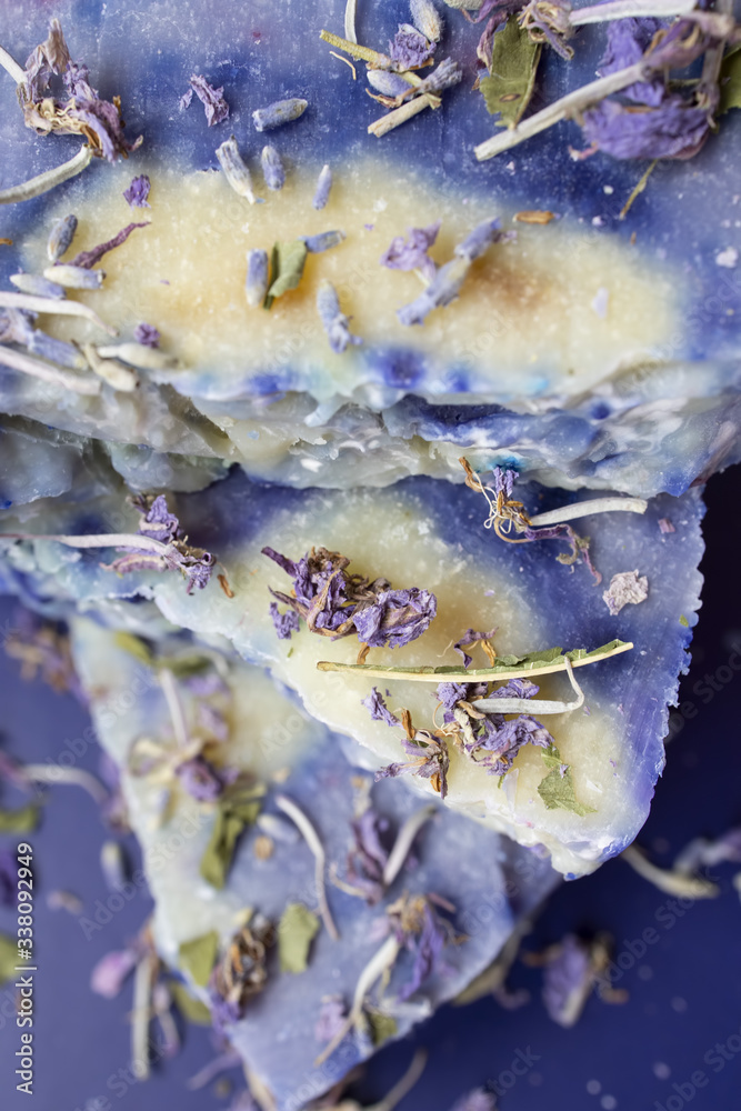 Hand made lavender soaps on the blue background. Natural cosmetic. Home business. Voluntary Isolation