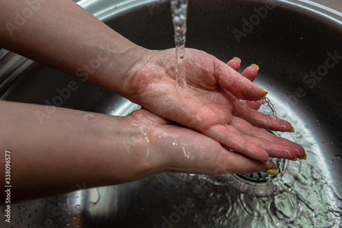 Woman's hands in water splash. Wash the hands